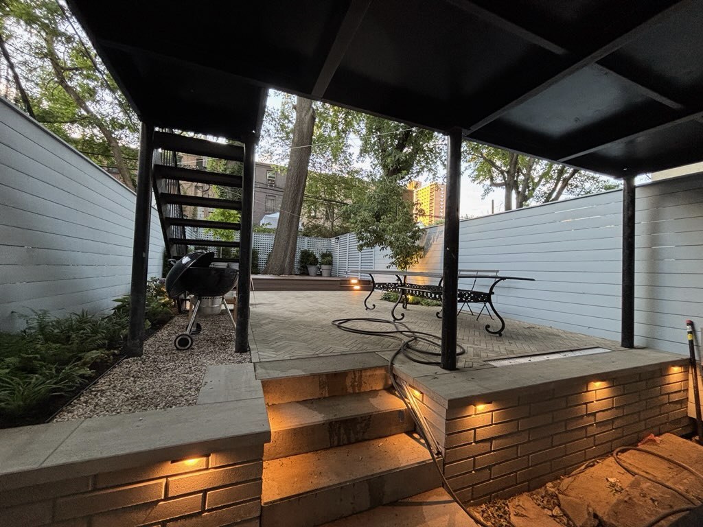 Covered patio with low-voltage step lighting and wall sconces